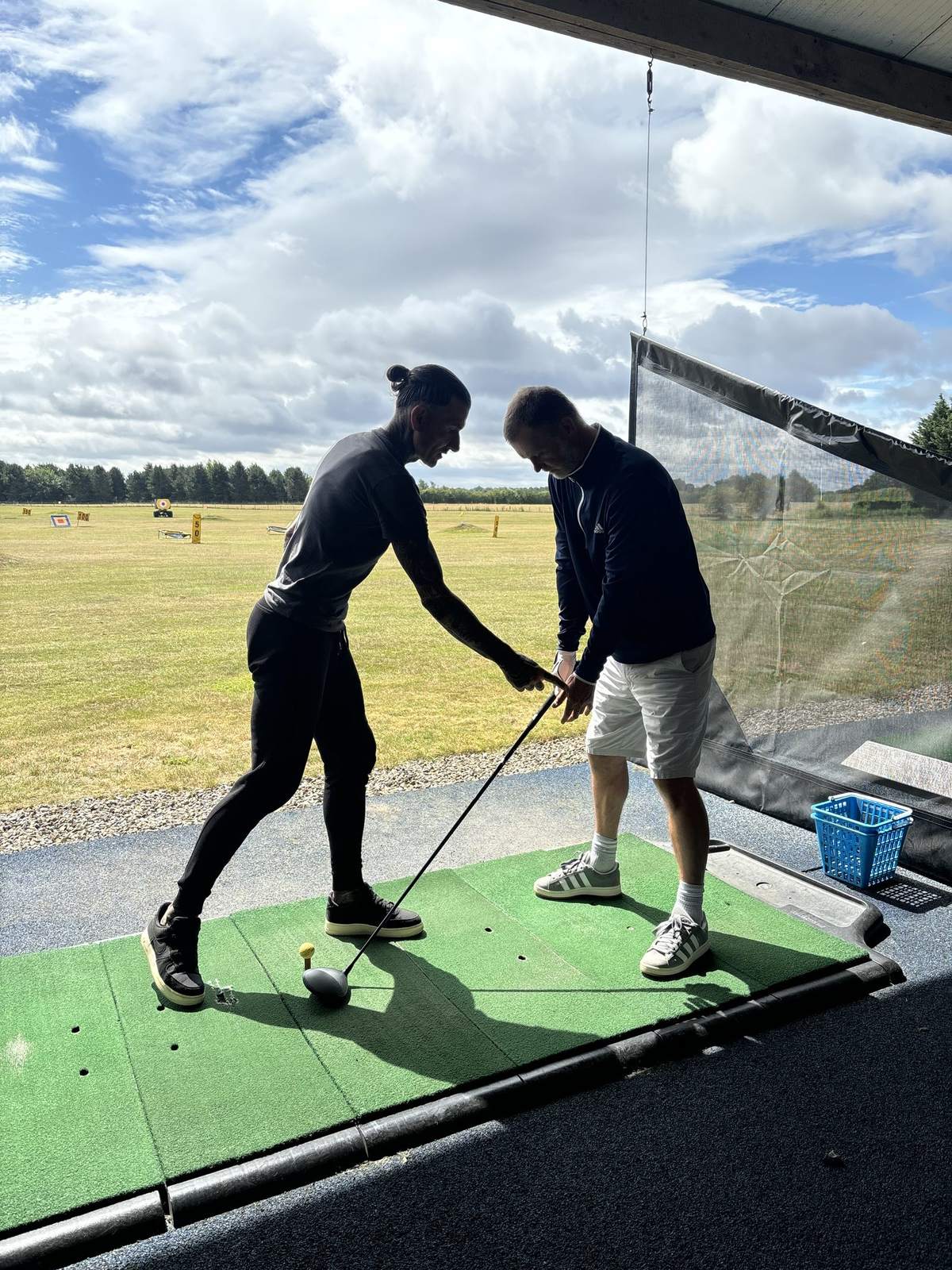 Dan adjusting a student's grip