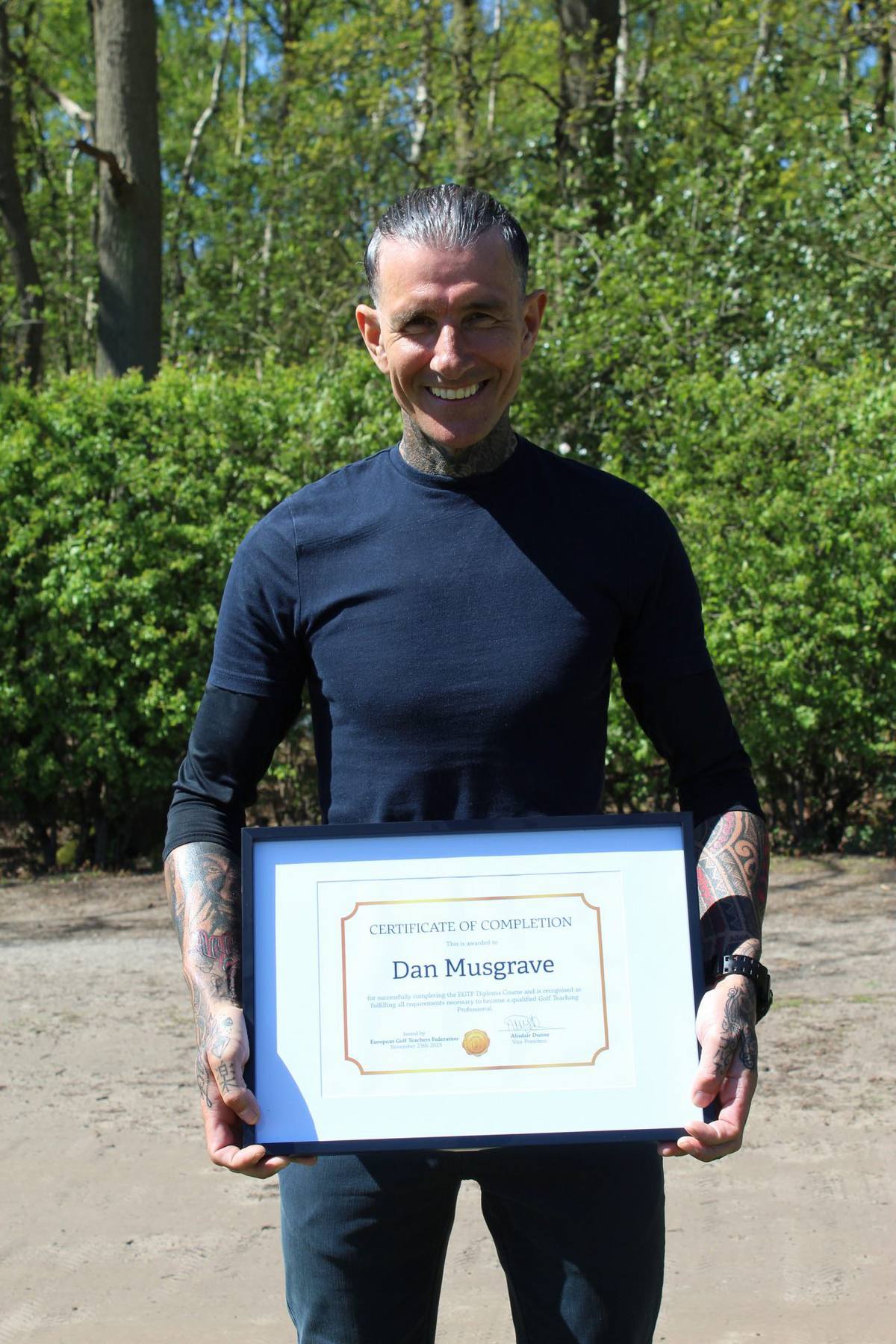 Dan Musgrave holding his EGTF golf teaching professional certificate