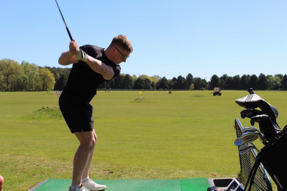 A student mid-swing on the driving range in York